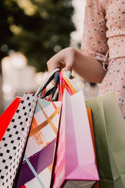 La dame tient beaucoup de sacs après le shopping