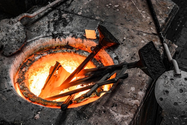 Dans un atelier de fonderie. Les barres métalliques en bronze sont fondues dans un creuset