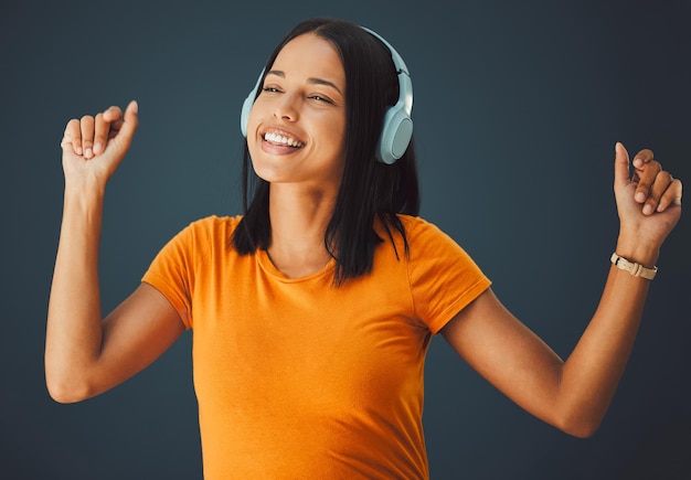 Danse femme noire ou casque pour le bonheur de la musique ou fille sur fond de studio sombre Danse fille afro-américaine ou casque sans fil pour le streaming radio ou écouter de l'audio sur fond