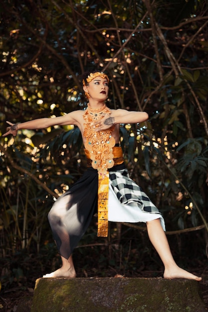 Un Danseur Traditionnel Avec Des Vêtements Dorés Et Une Couronne Dorée Posant Courageusement Dans La Jungle