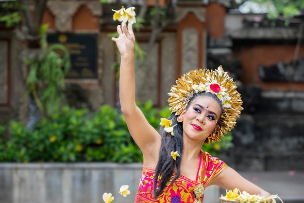 Danseuse Pendet femelle jetant une fleur de frangipanier