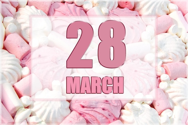 Photo date du calendrier sur fond de guimauves blanches et roses le 28 mars est le vingt-huitième jour du mois