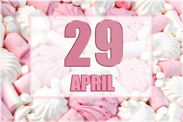 Date du calendrier sur fond de guimauves blanches et roses Le 29 avril est le vingt-neuvième jour du mois