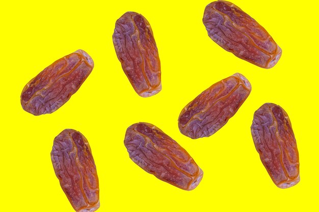 Datez les fruits sur fond jaune. Aliments traditionnels du Ramadan.