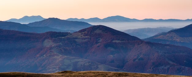 Début de l'aube dans les montagnes. Panorama brumeux du crépuscule du matin d'automne.