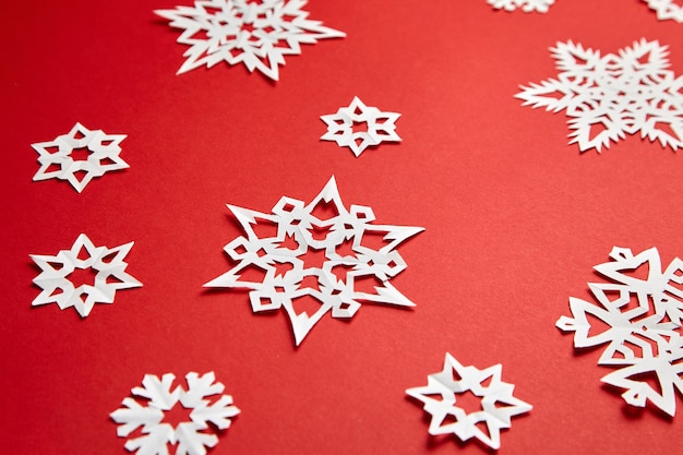 Décoration de Noël avec des flocons de papier blanc sur fond rouge