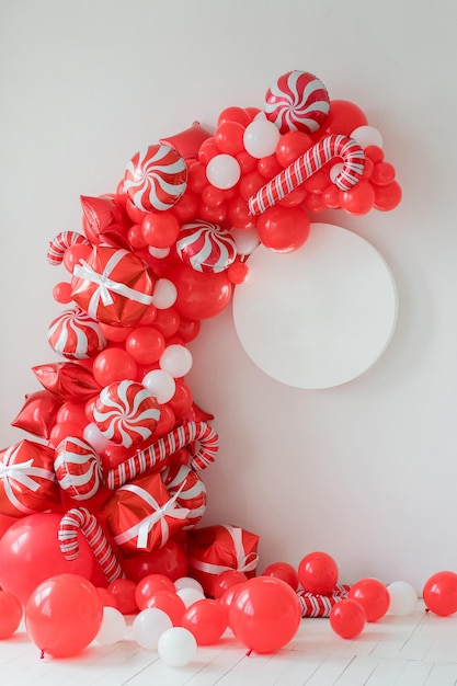 Décorations de fête de Noël rouges et blanches classiques avec des ballons à l'hélium. Maquette de cadre rond