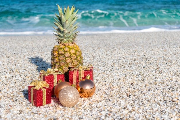 Décorations de Noël et boules sur le sable d'une plage