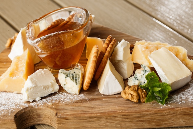 Dégustation de fromage sur une assiette en bois.