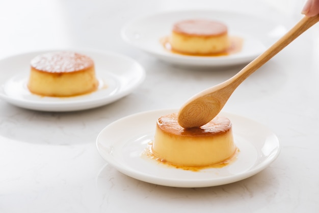 Délicieuse crème à la vanille en sauce caramel avec cuillère