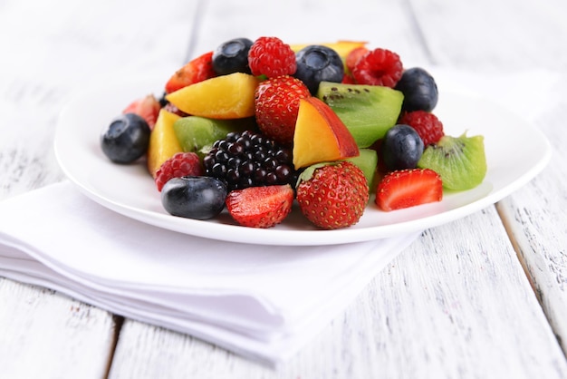 Délicieuse salade de fruits dans l'assiette sur le gros plan de table