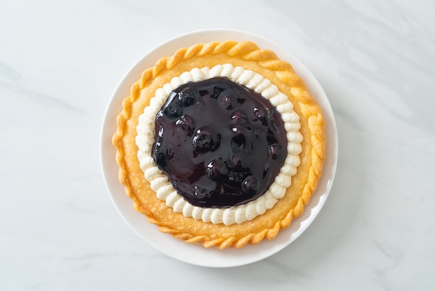 Délicieuse tarte au fromage aux bleuets sur plaque blanche