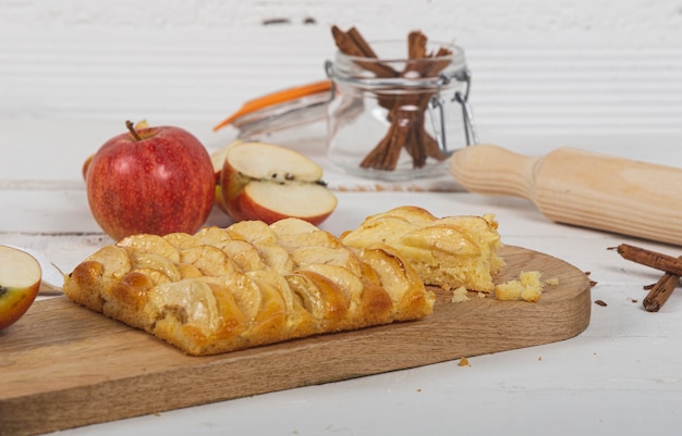 Délicieuse tarte aux pommes sur une table en bois blanc.