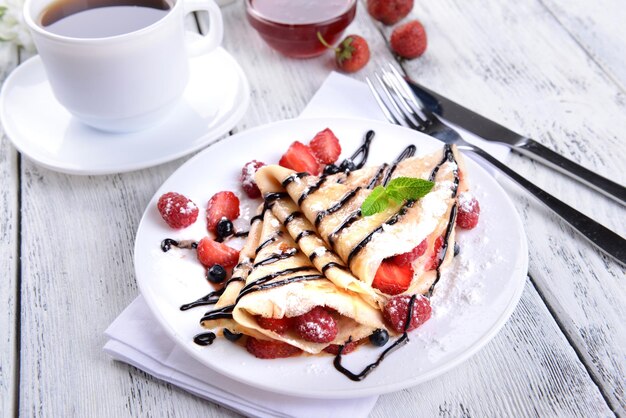 De délicieuses crêpes aux fruits rouges sur la table libre