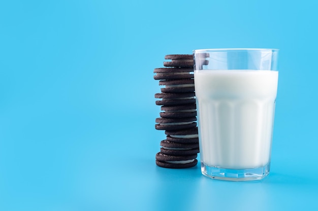 Délicieux biscuits aux pépites de chocolat noir sucré avec remplissage de lait isolé sur fond bleu