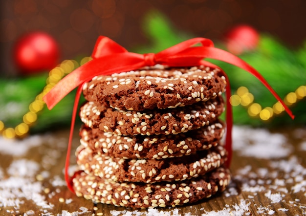 Délicieux biscuits de Noël en pot sur table sur fond marron