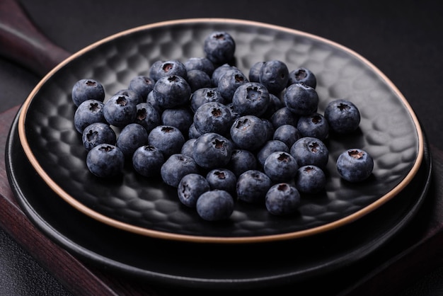 De délicieux bleuets frais sur un fond de béton noir texturé