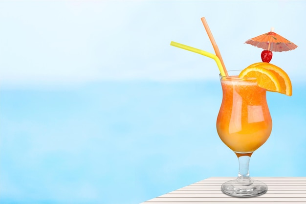 Délicieux cocktail avec glace et orange sur fond flou