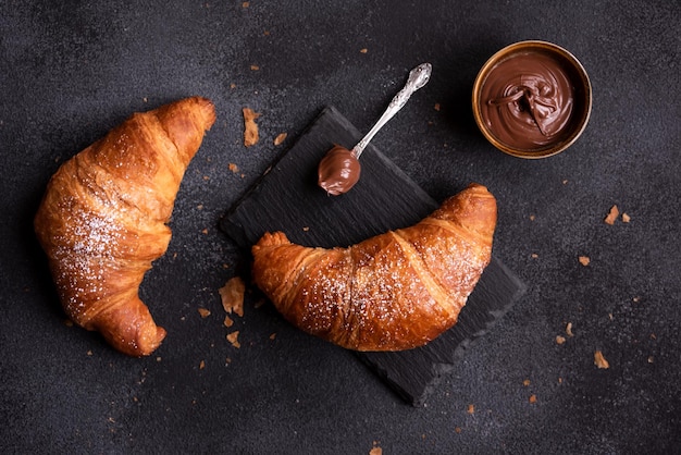 Délicieux croissant sucré au chocolat sur fond sombre