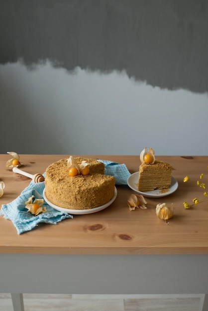 Délicieux gâteau au miel sur une assiette, sur une table en bois, décoré de fruits, une photo de nourriture est belle