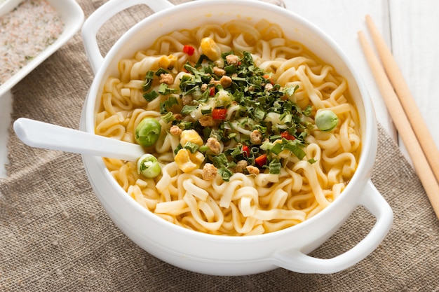 Délicieux ramen avec des légumes sur blanc