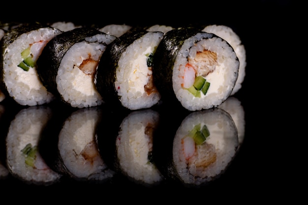 De délicieux rouleaux de sushi frais sur fond sombre