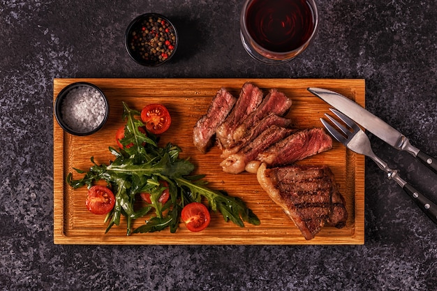 Délicieux steak de boeuf sur une planche de bois