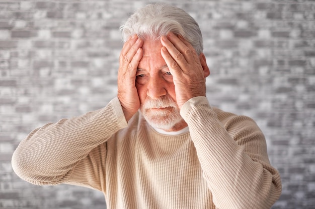 Désespéré malheureux vieil homme avec les mains dans le visage senior homme barbu souffrant de divorce mauvaise relation se sentant seul et déprimé