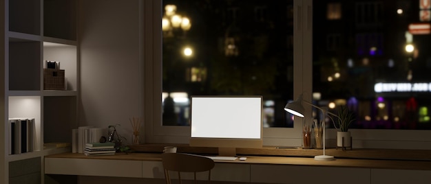 Design d'intérieur d'un bureau à domicile moderne la nuit avec une maquette d'ordinateur PC sur une table