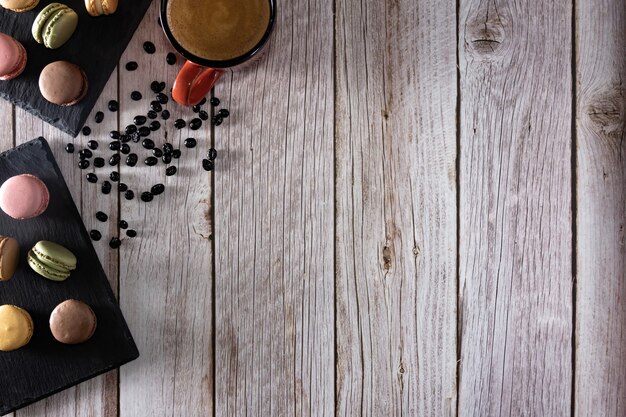 Dessert de macarons français avec une tasse de café et des grains de café Copy space