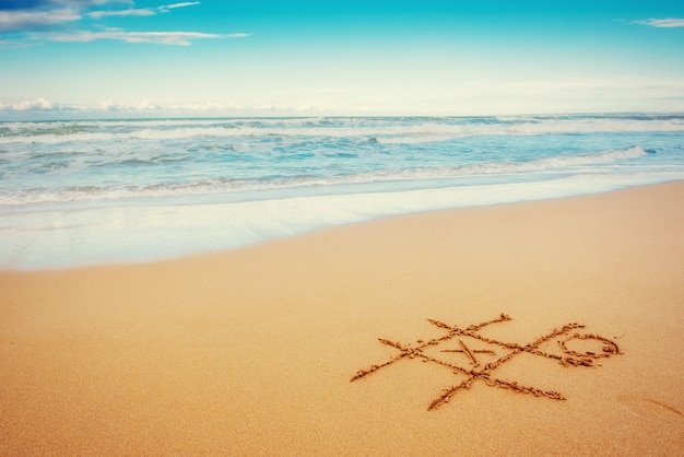 dessins dans le sable à la plage