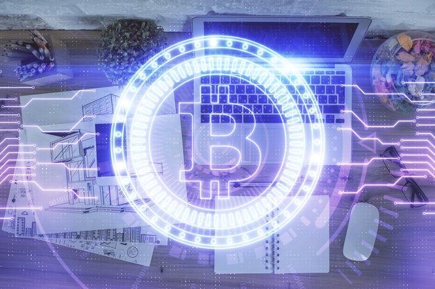 Dessins d'hologrammes sur le thème de la blockchain sur ordinateur sur fond d'écran Vue de dessus Double exposition