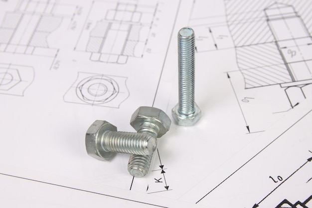 Photo dessins techniques de boulons et d'écrous technologie d'ingénierie et travail des métaux boulon et écrou en métal sur fond de dessins imprimés