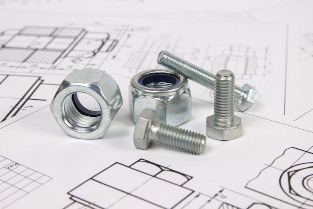Photo dessins techniques de boulons et d'écrous technologie d'ingénierie et travail des métaux boulon et écrou en métal sur fond de dessins imprimés