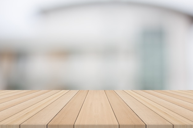 Dessus de table en bois sur fond flou blanc du bâtiment, pour le montage de vos produits