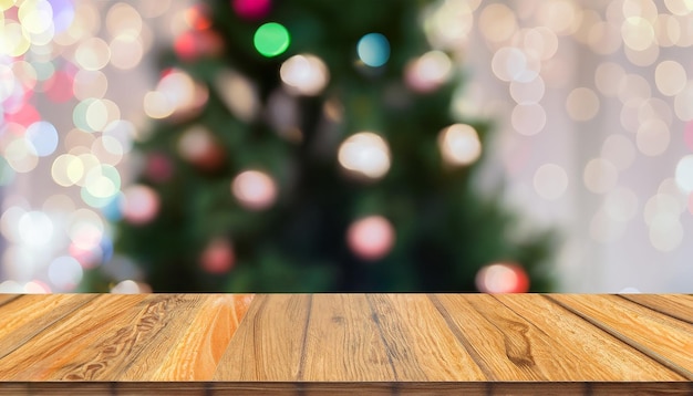 Dessus de table sombre en bois et fond de Noël bokeh arbre de Noël flou pour l'affichage ou le montage