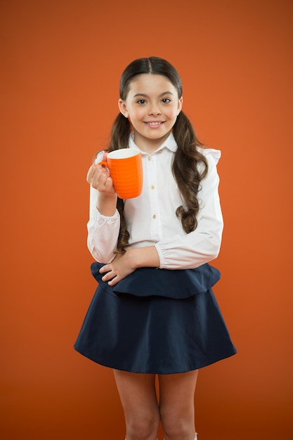 Détendez-vous et rechargez l'équilibre hydrique Boire du thé avant les cours Buvez suffisamment d'eau Boisson inspirante Fille buvez du cacao ou du thé Calories carburant pour le cerveau Écolière avec une tasse prenant le thé