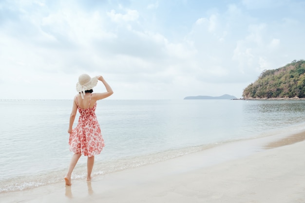 Photo détente femme sur le ciel de la plage et des nuages.