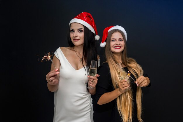 Deux amis avec des feux de Bengale et du champagne célébrant le nouvel an