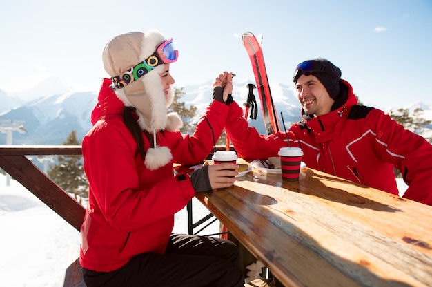 Deux amoureux et amis prenant un verre au bar de la station de ski.