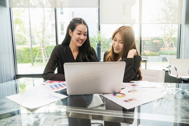 Deux Asiatique jeune femme d&#39;affaires assis et utilisant un ordinateur portable