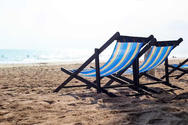 Deux chaise de plage sur la plage au coucher du soleil