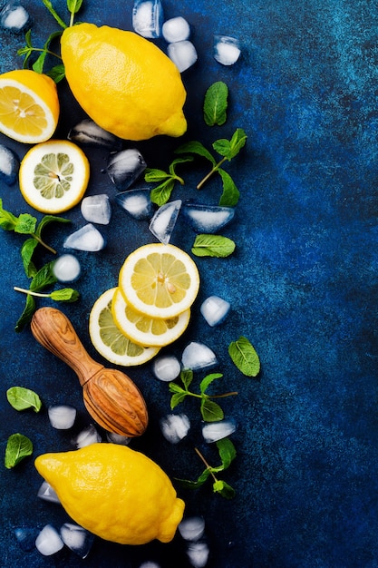Deux citrons frais en plaque bleu foncé sur une surface de béton turquoise. Surface alimentaire. Vue de dessus.