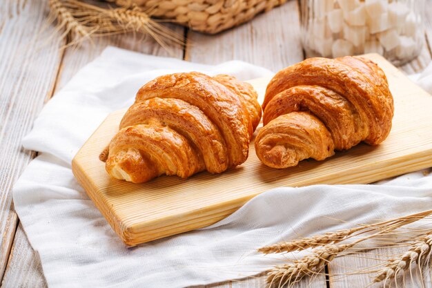 Deux croissants français sur la planche à découper en bois