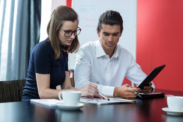 Deux dirigeants d'entreprise discutant sur graphique au bureau