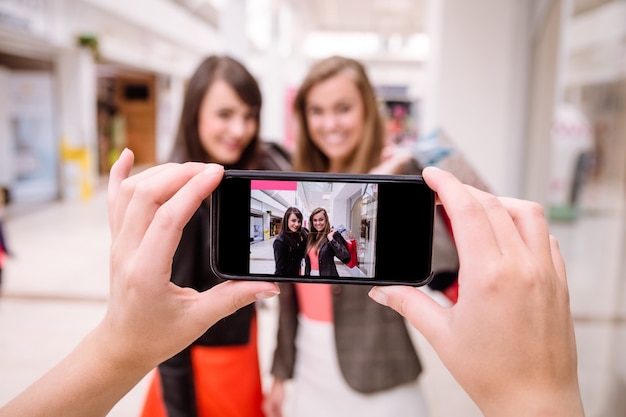 Deux femme en cliquant sur une photo dans le téléphone