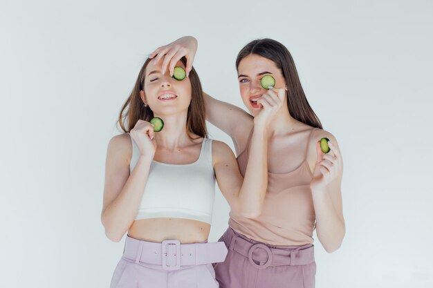 Deux filles fabriquent des masques de beauté faits maison pour le visage et les cheveux. Concombres pour la fraîcheur de la peau