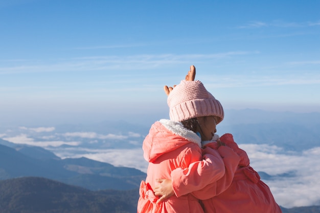 Deux filles mignonnes enfant asiatique portant pull et chapeau chaud embrassant ensemble