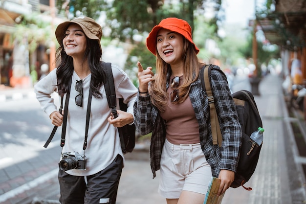 Deux filles randonneuses locales marchent à la recherche de destinations touristiques tout en marchant sur les bords des routes
