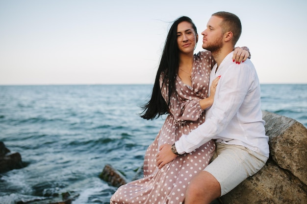 Deux jeunes couples assis sur la plage